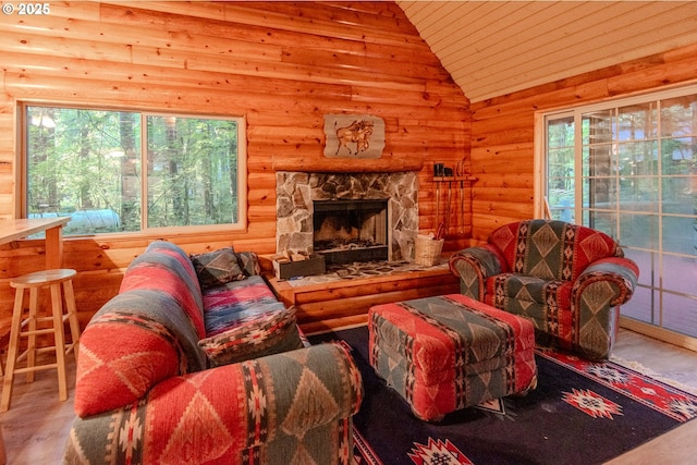 177 Northwoods, Cougar, WA 98616 - living area featuring lofted ceiling, wood ceiling, wood finished floors, a stone fireplace, and log walls