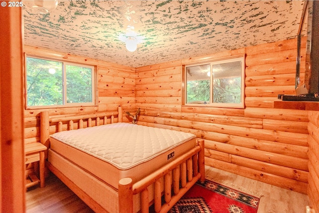 177 Northwoods, Cougar, WA 98616 - bedroom with rustic walls and wood finished floors