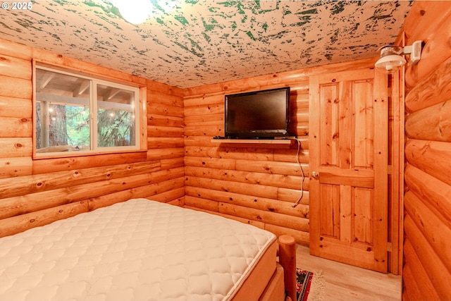 177 Northwoods, Cougar, WA 98616 - bedroom with log walls and light wood-style flooring