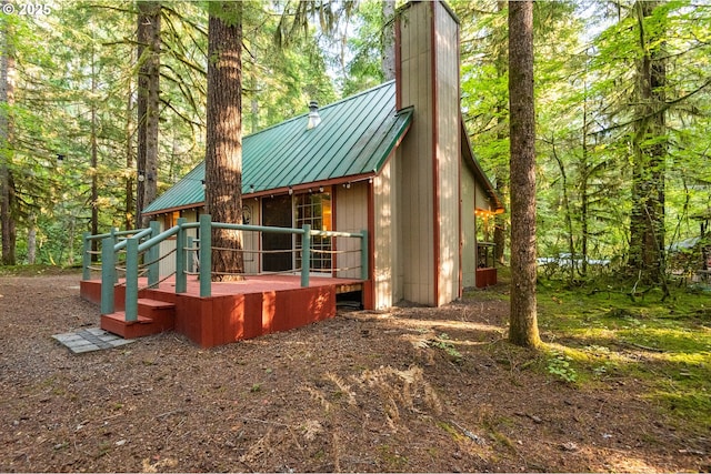 177 Northwoods, Cougar, WA 98616 - back of house with metal roof, a standing seam roof, a chimney, and a deck