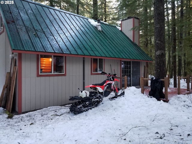 177 Northwoods, Cougar, WA 98616 - snow covered property with a chimney, metal roof, and a standing seam roof