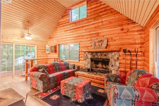 177 Northwoods, Cougar, WA 98616 - living area with rustic walls, high vaulted ceiling, wood finished floors, a stone fireplace, and a ceiling fan