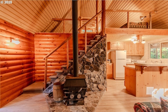177 Northwoods, Cougar, WA 98616 - unfurnished living room featuring rustic walls, stairs, wood ceiling, light wood-style flooring, and high vaulted ceiling