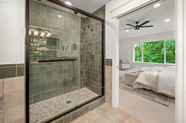 ensuite bathroom featuring ceiling fan, a shower stall, tile patterned flooring, and recessed lighting