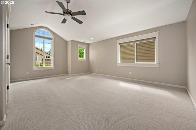 empty room with lofted ceiling, baseboards, a ceiling fan, and carpet floors