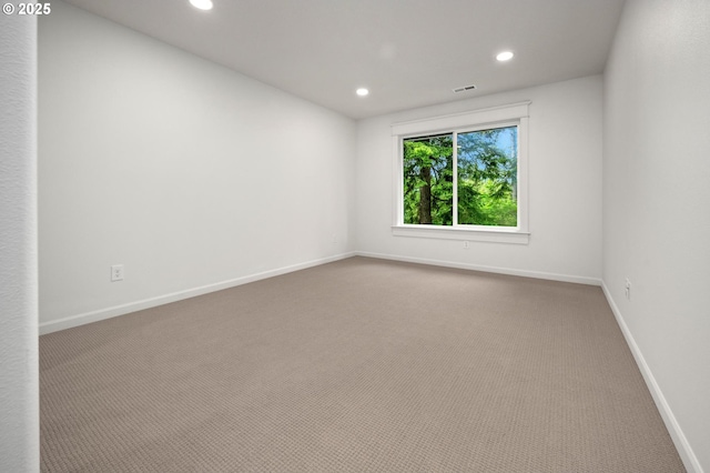 carpeted spare room featuring recessed lighting and baseboards
