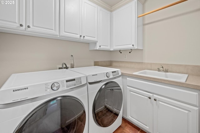 clothes washing area with separate washer and dryer, cabinet space, and tile patterned floors