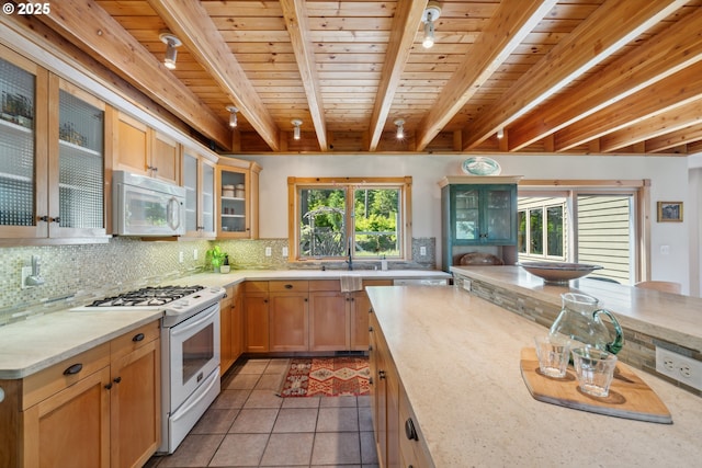 165 Stadelman Dr, Trout Lake, WA 98650 - kitchen with white appliances, tasteful backsplash, a wooden ceiling with exposed beams, light tile patterned floors, and glass insert cabinets