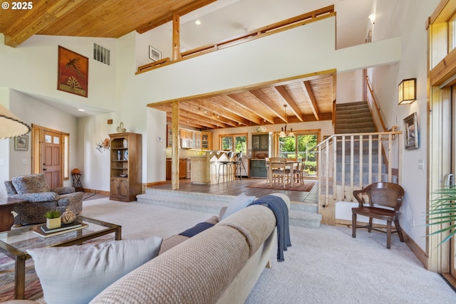165 Stadelman Dr, Trout Lake, WA 98650 - carpeted living room with stairway, a wooden ceiling with exposed beams, and a high ceiling