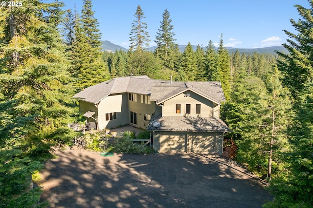 165 Stadelman Dr, Trout Lake, WA 98650 - view of front of house with a forest view, an attached garage, and driveway