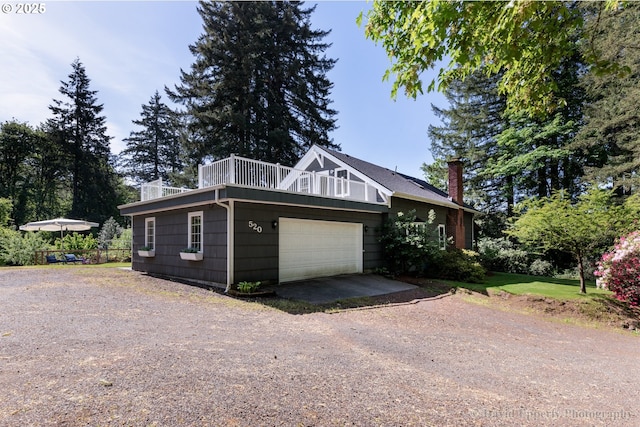 520 NE 5th St, Clatskanie, OR 97016 - view of side of property featuring a chimney, dirt driveway, and a garage