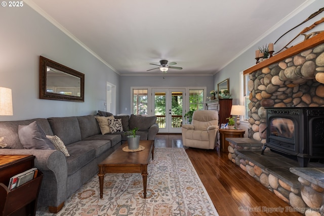 520 NE 5th St, Clatskanie, OR 97016 - living area featuring dark wood finished floors, a wood stove, ceiling fan, and ornamental molding