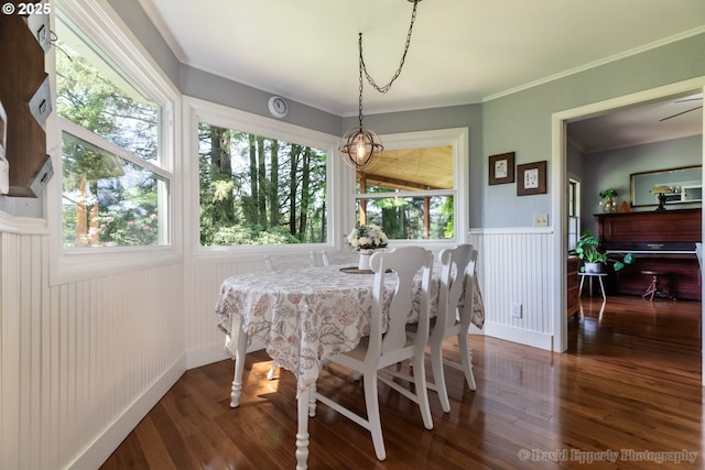 520 NE 5th St, Clatskanie, OR 97016 - dining space featuring a wainscoted wall, wood finished floors, and crown molding