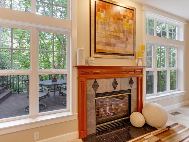 interior space with a tile fireplace