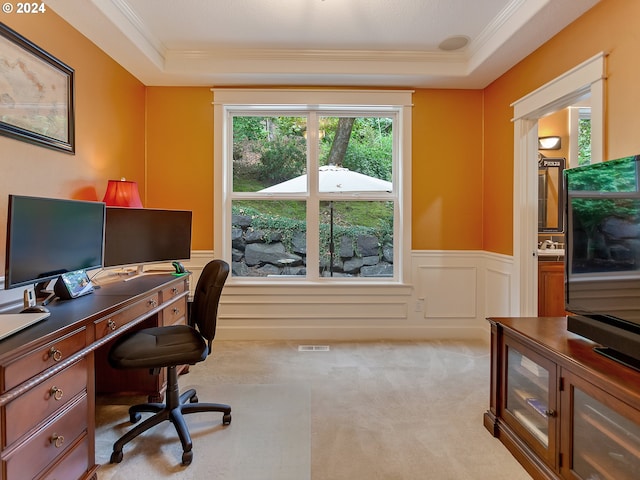 home office featuring a raised ceiling, light colored carpet, and ornamental molding