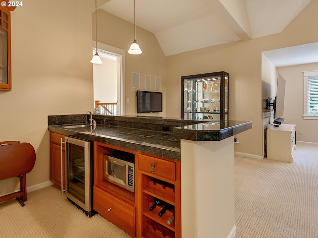 kitchen featuring light colored carpet, vaulted ceiling, beverage cooler, sink, and hanging light fixtures