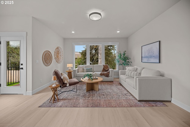 living area featuring recessed lighting, wood finished floors, and baseboards