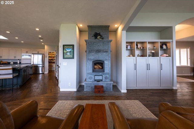 33685 Van Duyn Rd, Eugene, OR 97408 - living room featuring dark wood finished floors, baseboards, recessed lighting, and arched walkways