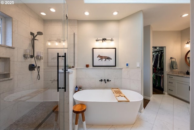 33685 Van Duyn Rd, Eugene, OR 97408 - bathroom with a stall shower, tile walls, vanity, a spacious closet, and a freestanding bath