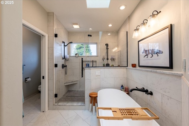 33685 Van Duyn Rd, Eugene, OR 97408 - full bathroom featuring a stall shower, a soaking tub, toilet, tile walls, and marble finish floors