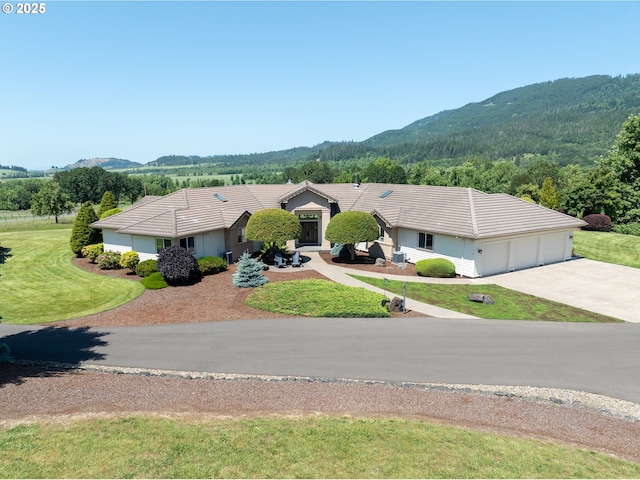 33685 Van Duyn Rd, Eugene, OR 97408 - view of front of home with a tiled roof, a mountain view, an attached garage, and driveway