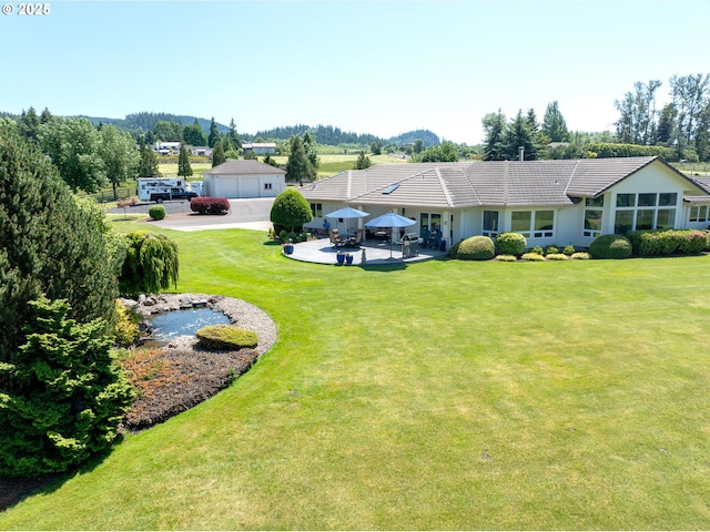 33685 Van Duyn Rd, Eugene, OR 97408 - view of green lawn with a patio area and a detached garage