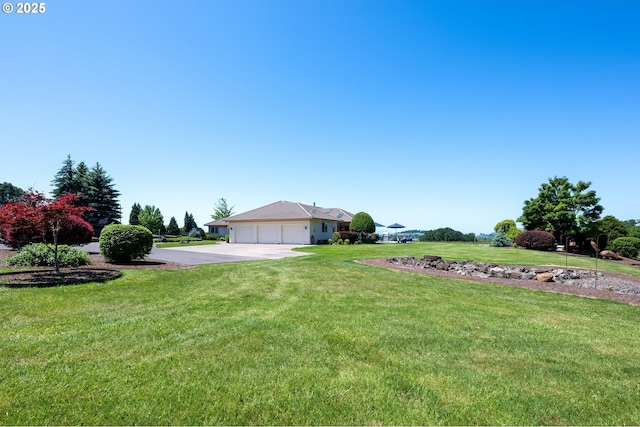 33685 Van Duyn Rd, Eugene, OR 97408 - view of grassy yard featuring concrete driveway and an attached garage