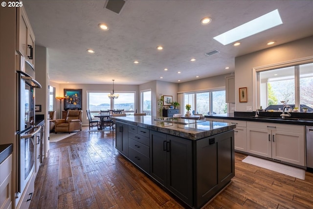 33685 Van Duyn Rd, Eugene, OR 97408 - kitchen with healthy amount of natural light, open floor plan, recessed lighting, a center island, and a chandelier