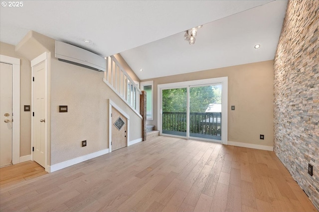 7752 SW Barnes Rd Unit B, Portland, OR 97225 - unfurnished living room featuring light wood-style floors, baseboards, stairs, a wall mounted air conditioner, and recessed lighting