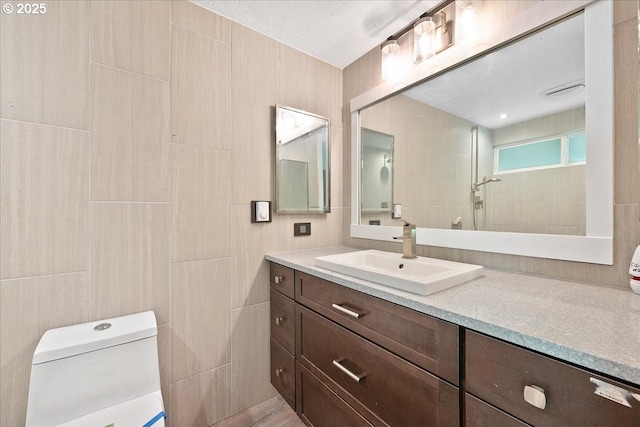 7752 SW Barnes Rd Unit B, Portland, OR 97225 - bathroom with toilet, tile walls, and vanity