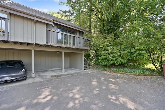 7752 SW Barnes Rd Unit B, Portland, OR 97225 - view of front of home with stairs, a shingled roof, and covered parking
