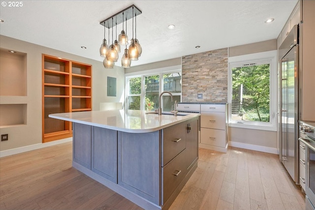 7752 SW Barnes Rd Unit B, Portland, OR 97225 - kitchen with a sink, light wood finished floors, light countertops, baseboards, and recessed lighting