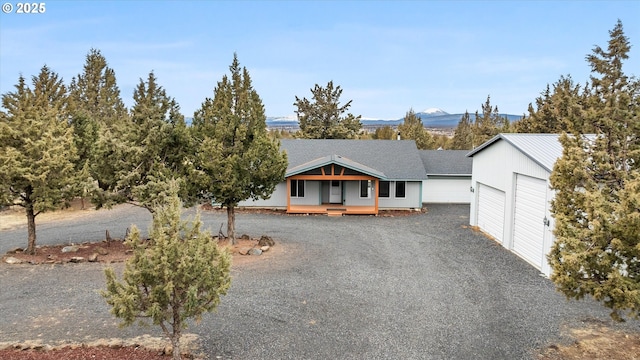 view of front facade with a mountain view and a garage