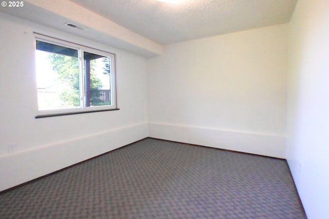 carpeted empty room with baseboards