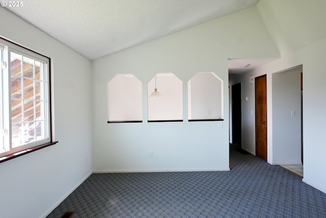 carpeted spare room featuring baseboards