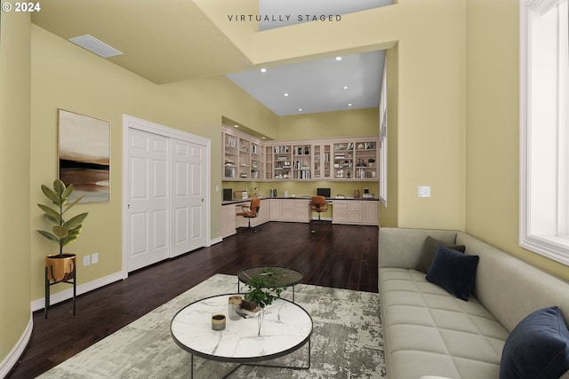 living room featuring built in study area, recessed lighting, dark wood finished floors, and baseboards
