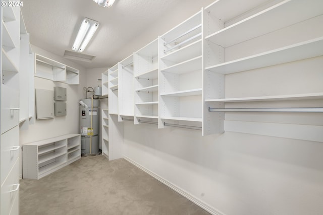 spacious closet with secured water heater and carpet floors