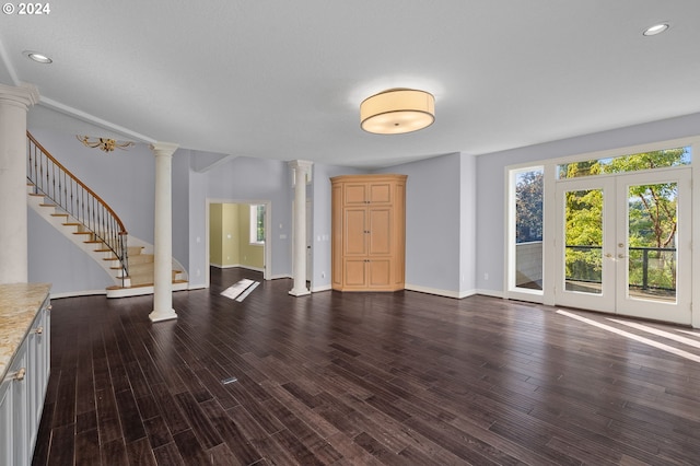 unfurnished living room with french doors, dark wood finished floors, stairs, ornate columns, and recessed lighting