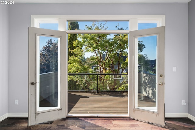 entryway with baseboards and wood finished floors