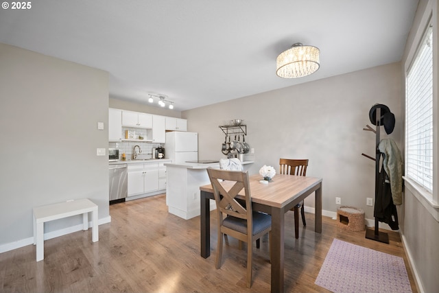 5582 SW Murray Blvd, Beaverton, OR 97005 - dining space with an inviting chandelier, baseboards, and light wood-type flooring