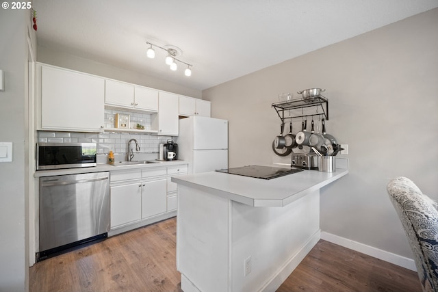 5582 SW Murray Blvd, Beaverton, OR 97005 - kitchen with open shelves, appliances with stainless steel finishes, a sink, a peninsula, and decorative backsplash