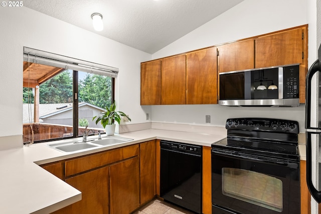 15210 SW 100th Ave, Portland, OR 97224 - kitchen featuring black appliances, vaulted ceiling, light countertops, brown cabinets, and a textured ceiling