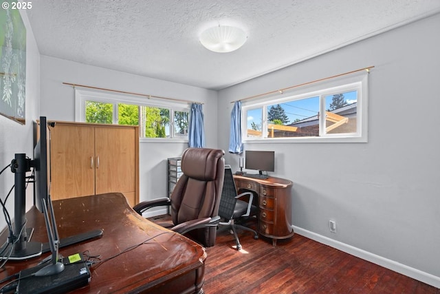 home office featuring a textured ceiling, wood finished floors, and baseboards