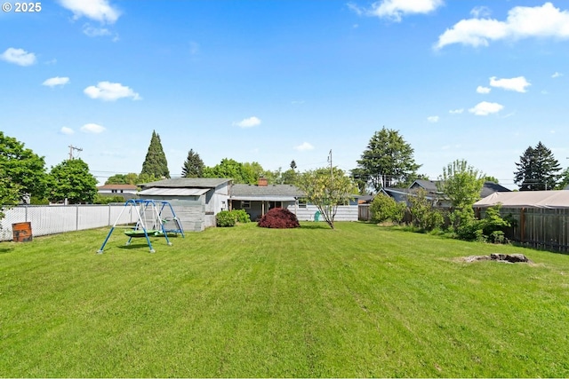 view of yard featuring a fenced backyard and a playground
