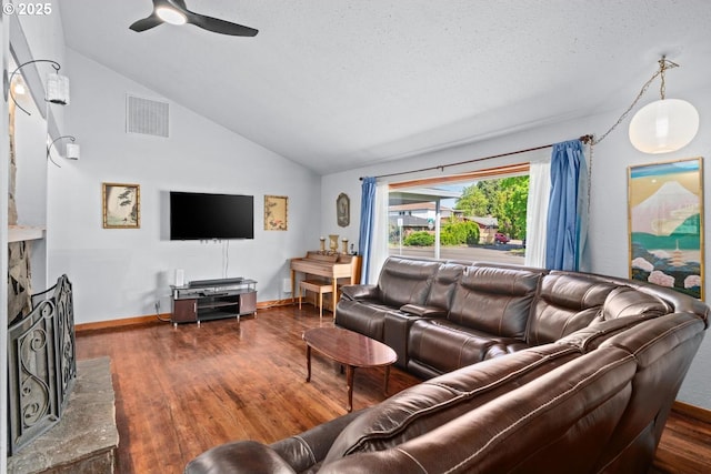 living room with lofted ceiling, wood finished floors, visible vents, ceiling fan, and baseboards