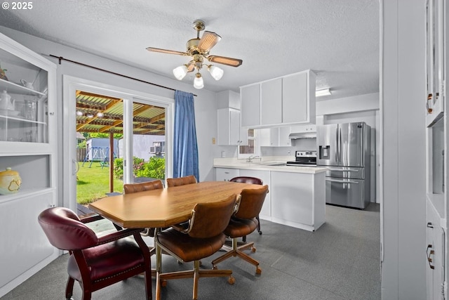 dining space featuring a textured ceiling and ceiling fan