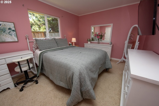 bedroom featuring light colored carpet, crown molding, and baseboards