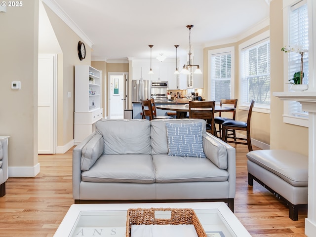 2696 SW Barnacle Ave, Lincoln City, OR 97367 - living area featuring a chandelier, crown molding, baseboards, and light wood finished floors