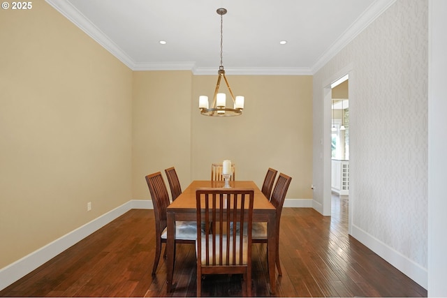 dining room with ornamental molding, a notable chandelier, baseboards, and dark wood-style floors