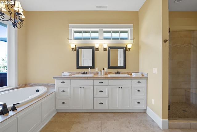 bathroom with a bath, a stall shower, plenty of natural light, and visible vents